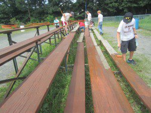 Scouts staining bleacher seats at the fairgrounds.  (Photo submitted)