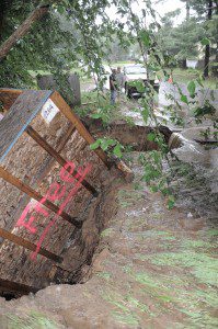 A contractor's storage container falls into a large ravine as parts of Canal Road in Westfield washed away after heavy rains hit the area Friday. (Photo by Frederick Gore) 