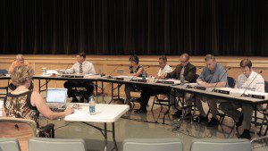 Westfield City Clerk Karen Fanion, foreground left, takes notes on a computer during last night's City Council meeting in the Westfield Middle School South auditorium. (Photo by Frederick Gore)