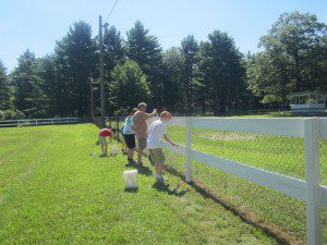 Daniel O’Connor, foreground, leads a work-party sprucing up the fences at the Westfield Fairgrounds.  (Photo submitted)