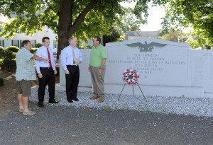 Southwick Selectmen Joseph Deedy, left, and Russell Fox, right, discuss improvements that will be made to the Southwick War Memorial with State Rep. Nicholas Boldyga, second from left, and State Sen. Michael Knapik, second from right, in front of the Southwick Congregational Church this morning. (Photo by Frederick Gore)