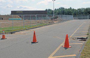 Contractors have erected a six-foot chain link fence around the main parking lot of the Southwick-Tolland-Granville Regional High School as renovations continue. School officials are notifying parents and students that parking will be restricted to a much smaller area around the school. (Photo by Frederick Gore)