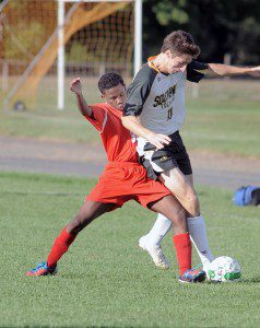 Southwick's Jonathan Collins, right, attempts to take control of a loose ball as Commerce midfielder Kymani Dayer moves in. (Photo by Frederick Gore)