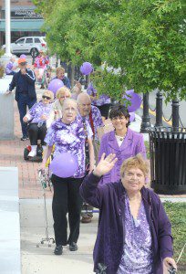 Olga Spagnoli waves to the camera as she walks in front of Olga Rios and City Councilor Agma Sweeney during a fundraising walk around Park Square to raise funds and awareness for the Alzheimer’s Association. (Photo by Carl E. Hartdegen)