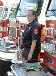 Carolyn Bradbury of the Southwick Fire Department rings a bell as part of a 9/11 Remembrance Ceremony in Southwick Wednesday. (Photo by Frederick Gore)