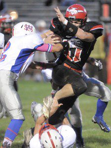 Westfield ball carrier Ben Geschwind rushes through West Springfield tacklers during last night's game. (Photo by Frederick Gore)