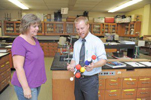 Westfield High School science instructor Ben Hatch shows an atomic structure model of a chemical compound to Kendra Mastello during an open house at Westfield High School last night. (Photo by Frederick Gore)