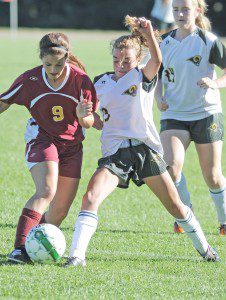 Southwick's Lydia Kinsman, right, battles Lenox for control of the ball during a 2013 contest. The Rams and Millionaires are set to make their mark again when the soccer tournaments resume with semifinal action Tuesday-Thursday. (File Photo)