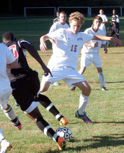 Westfield's Andy Garfield (15) pries the ball away from Renaissance's John Togba Wednesday in Huntington. (Photo by Chris Putz)