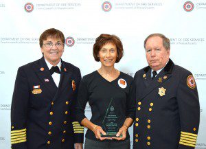 Tina Gorman, the director of the Westfield Council on Aging, is flanked by Westfield Fire Chief Mary Regan and Massachusetts Fire Marshal Stephen D. Coan, was she displays the 2013 Fire & Life Safety Educator of the Year Award she received recently at the 19th annual Public Fire and Life Safety Education Conference. (Photo courtesy the Department of Fire Services)