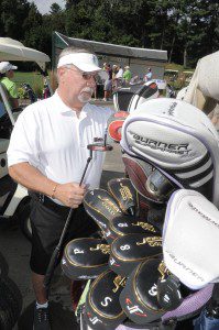 Bob Loomis checks his golf clubs prior to teeing off at the Friends of the Columbia Greenway Rail Trail fundraiser staged at the Shaker Farms Country Club in September of 2013. (File photo by Frederick Gore)