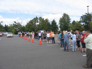 Western Mass. residents wait in line to register for new E-ZPass transponders in the parking lot of Chicopee’s Big Y Supermarket on Memorial Drive yesterday. (Photo by Peter Francis)