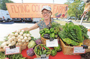 Julie Cummings, co-owner of the Flying Colors Farm in Florence, displays some of the fresh produce at the Westfield Farmers Market Thursday. (Photo by Frederick Gore)