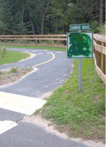 A sign barring motorized vehicles from the Columbia Greenway rail trail where it crosses Shaker Road was covered with spray paint recently and an obscenity was painted on the nearby pavement. (Photo courtesy Columbia Greenway)