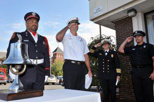 Westfield firefighter/paramedic, Randy Quarles, left, prepares to ring a ceremonial bell during a 911 remembrance ceremony at the Westfield Fire Department. (File photo by Frederick Gore)