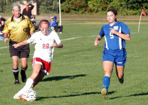 Westfield's Morgan Sanders (22) dribbles the ball as a West Springfield player attempts to track down the ball. (Photo by Chris Putz)