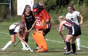 Westfield goalie Karly Mastello gets a foot under the ball as players from both the Bombers and the Longmeadow Lancers swarm the play. (Photo by Chris Putz)