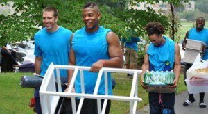 Members of the Westfield State football team assist first-year students during move-in day.