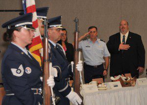  Standing next to Representative Donald Humason, Jr. (R-Westfield), 104th Fighter Wing Commander Col. James Keefe salutes the colors prior to the Greater Westfield Chamber of Commerce September breakfast at Barnes Air Base. (Photo by 104th Fighter Wing Senior Master Sgt. Robert J. Sabonis)