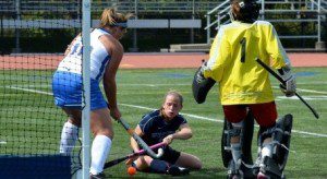 A hustling Kelly Kenney scores her second goal of the game as she pokes the ball past a Roger Williams defender. (Photo by Mickey Curtis)