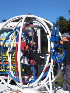 A daring young man gets ready to spin at one of several rides and games at Stanley Park for the Autism Speaks fundraising walk Saturday, (Photo by Hope E. Tremblay)