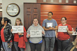 Westfield State University students hold signs in opposition to WSU President Evan Dobelle's comment in a The Boston Globe article about some students being "throwaway kids." Dobelle in an earlier meeting said the statement was possibly taken out of context and that he spent funds treating three disadvantaged students to New York in a limo in 2009. (File photo by Frederick Gore)
