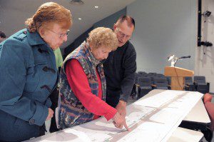 Rose Crawford, Beverly Crawford and Gerry Crawford, all residents of the Western Avenue area, examine a set of drawings of the proposed improvements that will be made to Western Avenue and Court Street during a public informational meeting last night at Westfield Middle School South. (Photo by Frederick Gore)