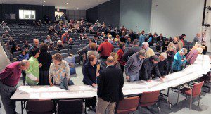 Residents gather around a set of tables to examine a set of drawings during the Western Avenue and Court Street Improvement Project Informational Meeting at Westfield Middle School South last night. (Photo by Frederick Gore)