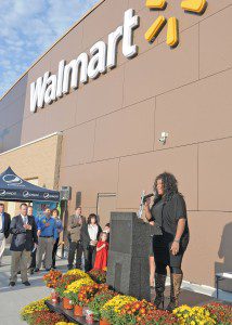 Michelle Brooks-Thompson, right, of Amherst, a 2012 contestant on NBC's The Voice, sings the National Anthem during the grand re-opening ceremony of the Westfield Walmart Wednesday. (Photo by Frederick Gore)