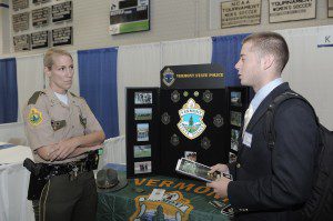 Westfield State University senior D.J. O'Neil, right, of Hanover, questions Vermont State Trooper Stephanie Shaw on the opportunities of a career in law enforcement during a career fair at the university yesterday. (Photo by Frederick Gore)