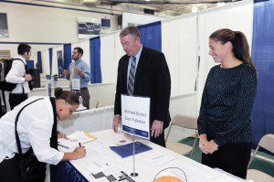 Westfield State University senior Ruthie May Therrien, of Chicopee, left, fills in her contact information to become a court intern with Westfield District Court as Probation Officers John Hoar and Laura Dion look on during a career fair at the school yesterday. (Photo by Frederick Gore)