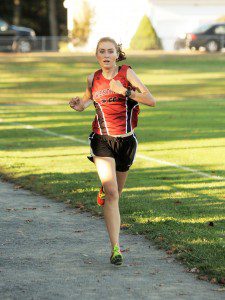 Westfield's Allyson Morin crosses the finish line with a time of 19:16 during yesterday's tri-meet with Southwick and Belchertown. Morin set a new 3.1-mile record time for the Southwick course. (Photo by Frederick Gore)