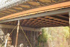 New steel and wood bracing secures the underside of the Pochassic Street Bridge Friday. The bridge was deemed unsafe and closed to vehicle traffic in 2010 by the Department of Transportation. (Photo by Frederick Gore)