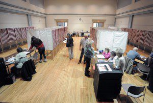 Poll workers at the Southwick Town Hall assist residents during yesterday's Special Election Primary for 2nd Hampden and Hampshire State Senator position. (Photo by Frederick Gore)