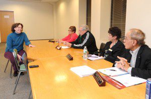 Kenneth Magarian (right), chair of the Westfield Parks and Recreation Department, listens with other commissioners as Marilyn Sandidge, vice-president of the Friends of  the Westfield Dog Bark, speaks to the commission about the enclosure recently erected by the Friends at Arm Brook Park to make it a "dog friendly" park. (Photo by Carl E. Hartdegen)