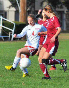 Westfield sophomore forward Shelby Chambers, left, battles a pair of Amherst defenders. (Photo by Frederick Gore)