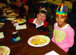 Timothy Moran and Jiani Rijos, both 6, eat Thanksgiving dinner at the Boys & Girls Club of Greater Westfield. (Photo submitted)