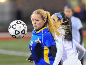 Gateway junior midfielder Caroline Booth, left, traps the ball as a Monson defender moves in during Sunday night's MIAA Western Mass. Division IV girls' soccer title game at Westfield State University. (Photo by Frederick Gore)