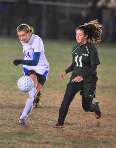 Gateway's Kendall Rooney kicks the ball as a McCann player can only watch. (Photo by Frederick Gore)