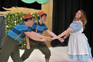 Southwick-Tolland Regional High School Performing Arts students Jacob Blumenthal and Timothy Fontaine, left, as Tweedledee and Tweedledum, dance with Erica Paul, as Alice, in the upcoming performance of Alice in Wonderland which will take the stage Friday and Saturday, Nov. 22 and 23 at 7:30 p.m. and Saturday and Sunday, Nov. 23 and 24 at 2 p.m. in the school auditorium. General admission is $7 and $5 for students and seniors. (Photo by Frederick Gore)