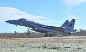 Capt. Osme Benedict of the 104th Fighter Wing at Barnes Regional Airport gives a thumbs up signal from the cockpit of an F-15 fighter jet as he lands on the newly reconstructed 9,000-foot runway that opened yesterday. (Photo by Frederick Gore)