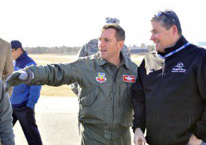 Col. James P. Keefe, left, commander of the 104th Fighter Wing, points to an F-15 aircraft as Brian Barnes, Barnes Regional Airport manager, celebrates the newly reconstructed 9,000-foot runway at the airport. Four F-15 attack aircraft returned to the base yesterday. (Photo by Frederick Gore)
