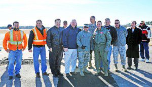 Officials and airport contractors celebrate the opening of a newly reconstructed 9,000-foot runway at Barnes Regional Airport as four F-15 fighter aircraft returned to the base yesterday. (Photo by Frederick Gore)