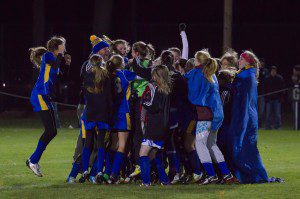 Gateway players jump into a big huddle after winning their Western Mass semifinal game against Cathedral Friday night at Szot Park. (Photo by Noah Buchanan)