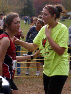 Alexa Morin, right, shares an emotional moment with her sister, Ally, who moments before finished runner-up in the PVIAC championships at Stanley Park Saturday. (Photo by Chris Putz)