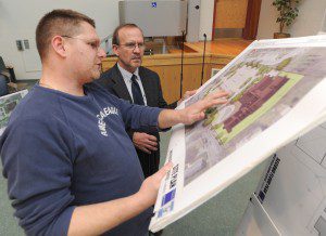 Noble Street resident Brian Judd discusses the design of a new senior center planned for a site on his street with Peter H. Wells, a principal of The Berkshire Design Group Inc. after a public hearing staged at Westfield Middle School South last night to inform residents about the planned senior center. (Photo by Carl E. Hartdegen)  