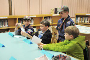Westfield Cub Scout Pack 108 members Matt Collins, second from left, reads a Westfield city budget item during a mock city council meeting with, left-right, Aidan Thomas, Billy Fouche and Cameron Klee during a scouting exercise at the Paper Mill Elementary School yesterday. The scouts were participating in a mock city budget exercise to help earn their Citizenship Badge. The class was spearheaded by scout leader and city councilor Dave Flaherty. (Photo by Frederick Gore)