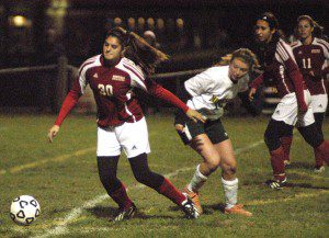 Westfield's Becca Sullivan beats a Minnnechaug player to the ball during Tuesday night's WMass D1 girls' soccer quarterfinal game. (Photo by Chris Putz)