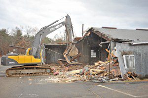 Contractors from Jay-Mor Company of Pelham, New Hampshire, razed the former Southwick Department of Public Works building located in the rear of the Southwick Police Department Monday. (Photo by Frederick Gore)