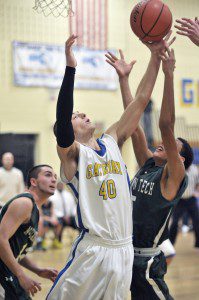 Gateway's Calvin Dowers, center, battles for the rebound during last night's game against visiting McCann Tech in Huntington. (Photo by Frederick Gore)